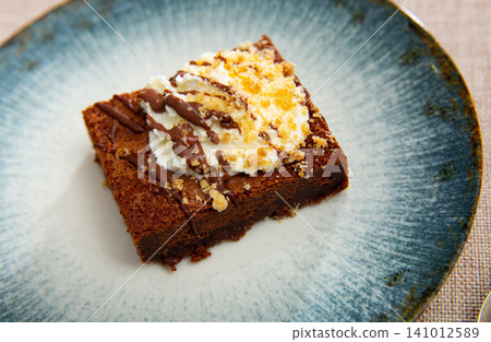 Chocolate brownie cake served for dessert Chocolate brownie cake served for dessert 141012589
