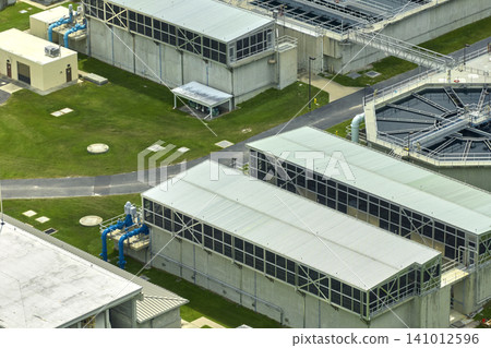 Aerial view of modern water cleaning facility at urban wastewater treatment plant. Purification process of removing undesirable chemicals, suspended solids and gases from contaminated liquid Aerial view of modern water cleaning facility at urban wastewater treatment plant. Purification process of removing undesirable chemicals, suspended solids and gases from contaminated liquid 141012596