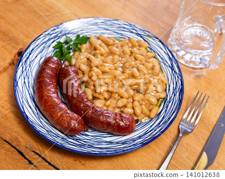 Fried sausages served with beans on plate Fried sausages served with beans on plate 141012638