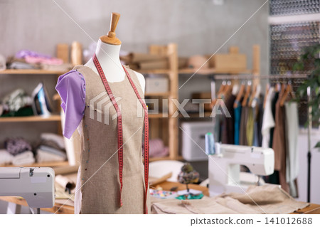 Unfinished dress on mannequin in tailoring studio 141012688