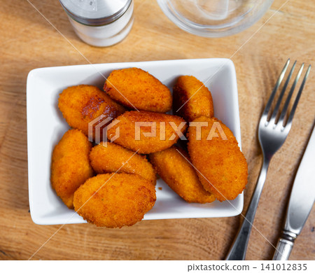 Potato croquettes - mashed potatoes balls breaded and deep fried, served with sauce Potato croquettes - mashed potatoes balls breaded and deep fried, served with sauce 141012835