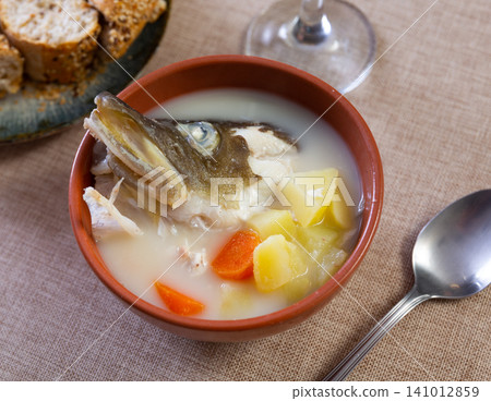 Cod and cheese soup served in bowl Cod and cheese soup served in bowl 141012859