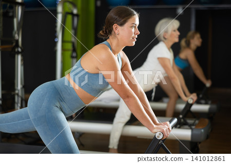 Woman doing exercises for gluteal muscles and legs Woman doing exercises for gluteal muscles and legs 141012861