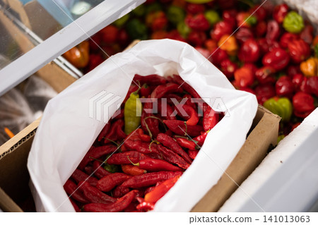 Whole frozen red sweet pepper are in shopwindow refrigerator. Whole frozen red sweet pepper are in shopwindow refrigerator. 141013063