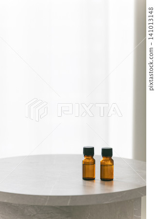 Two aromatherapy bottles are placed on the table. Copy space available. Two aromatherapy bottles are placed on the table. Copy space available. 141013148