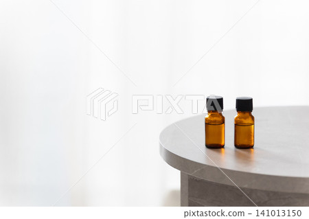 Two aromatherapy bottles are placed on the table. Copy space available. Two aromatherapy bottles are placed on the table. Copy space available. 141013150