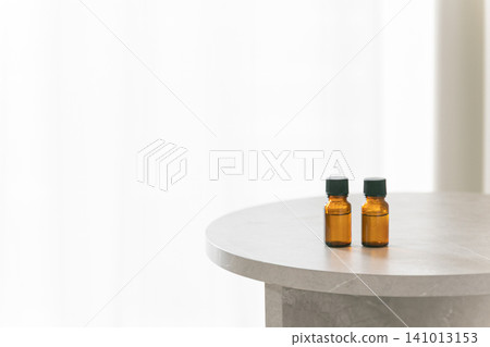 Two aromatherapy bottles are placed on the table. Copy space available. Two aromatherapy bottles are placed on the table. Copy space available. 141013153