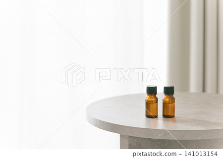 Two aromatherapy bottles are placed on the table. Copy space available. Two aromatherapy bottles are placed on the table. Copy space available. 141013154