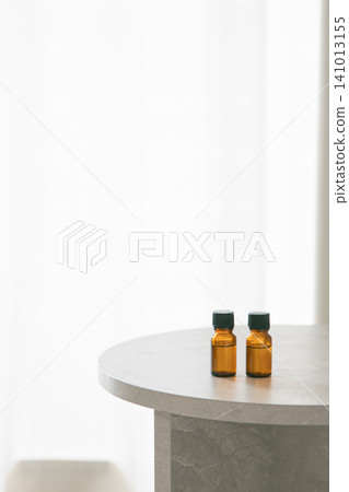 Two aromatherapy bottles are placed on the table. Copy space available. Two aromatherapy bottles are placed on the table. Copy space available. 141013155