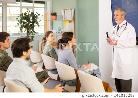 Elderly male medical professor gives lecture to group of students Elderly male medical professor gives lecture to group of students 141013292