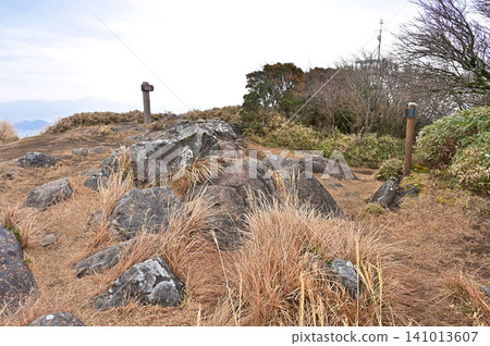 Izu Mountain Ridge Trail on the Izu Peninsula: The summit of Mt. Kinkan under a cloudy sky. Izu Mountain Ridge Trail on the Izu Peninsula: The summit of Mt. Kinkan under a cloudy sky. 141013607