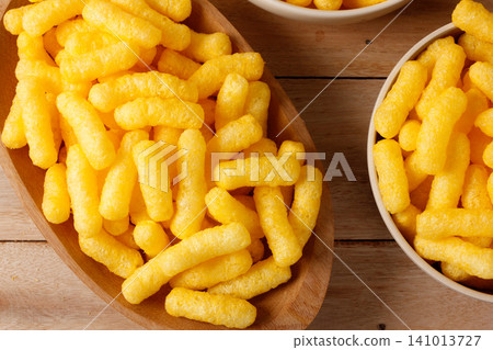 Crispy corn sticks in a wooden dish on a rustic table Crispy corn sticks in a wooden dish on a rustic table 141013727