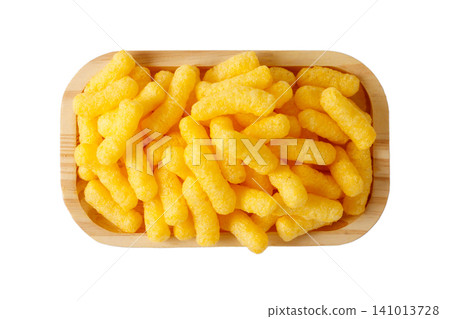 Crispy corn sticks on a wooden plate, isolated on a white background 141013728