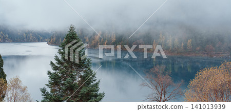 Scenery Jiuzhaigou national park in Sichuan, China. Beautiful Long lake and snow mountain in Autumn season. Famous Landmark and Vacation near Chengdu, China. Asia travel concept 141013939