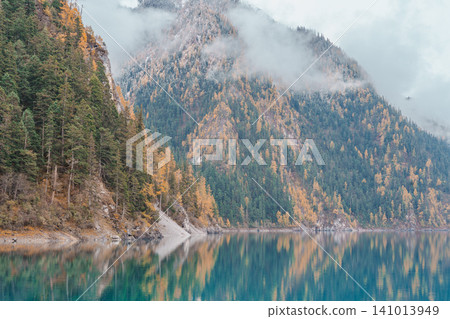 Scenery Jiuzhaigou national park in Sichuan, China. Beautiful Long lake and snow mountain in Autumn season. Famous Landmark and Vacation near Chengdu, China. Asia travel concept Scenery Jiuzhaigou national park in Sichuan, China. Beautiful Long lake and snow mountain in Autumn season. Famous Landmark and Vacation near Chengdu, China. Asia travel concept 141013949