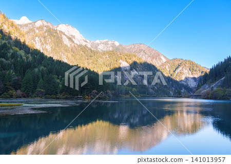 Scenery Jiuzhaigou national park in Sichuan, China. Beautiful of Arrow Bamboo Lake and snow mountain in Autumn season. Famous Landmark and Vacation near Chengdu, China. Asia travel concept Scenery Jiuzhaigou national park in Sichuan, China. Beautiful of Arrow Bamboo Lake and snow mountain in Autumn season. Famous Landmark and Vacation near Chengdu, China. Asia travel concept 141013957