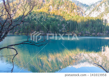 Scenery Jiuzhaigou national park in Sichuan, China. Beautiful of Arrow Bamboo Lake and snow mountain in Autumn season. Famous Landmark and Vacation near Chengdu, China. Asia travel concept Scenery Jiuzhaigou national park in Sichuan, China. Beautiful of Arrow Bamboo Lake and snow mountain in Autumn season. Famous Landmark and Vacation near Chengdu, China. Asia travel concept 141013958