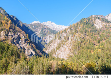 Scenery Jiuzhaigou national park in Sichuan, China. Beautiful of Arrow Bamboo Lake and snow mountain in Autumn season. Famous Landmark and Vacation near Chengdu, China. Asia travel concept Scenery Jiuzhaigou national park in Sichuan, China. Beautiful of Arrow Bamboo Lake and snow mountain in Autumn season. Famous Landmark and Vacation near Chengdu, China. Asia travel concept 141013961