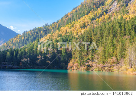 Scenery Jiuzhaigou national park in Sichuan, China. Beautiful of Arrow Bamboo Lake and snow mountain in Autumn season. Famous Landmark and Vacation near Chengdu, China. Asia travel concept Scenery Jiuzhaigou national park in Sichuan, China. Beautiful of Arrow Bamboo Lake and snow mountain in Autumn season. Famous Landmark and Vacation near Chengdu, China. Asia travel concept 141013962