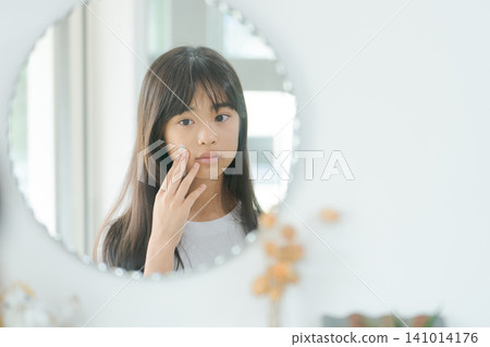 Elementary school girl doing skincare Elementary school girl doing skincare 141014176