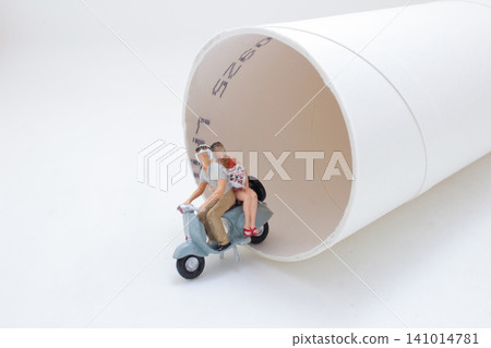 Miniature Scooter Couple Beside Paper Cup Tunnel Miniature Scooter Couple Beside Paper Cup Tunnel 141014781