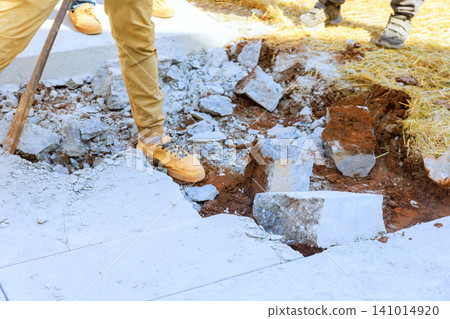 Workers remove concrete dig into ground at construction site during work hours. Workers remove concrete dig into ground at construction site during work hours. 141014920