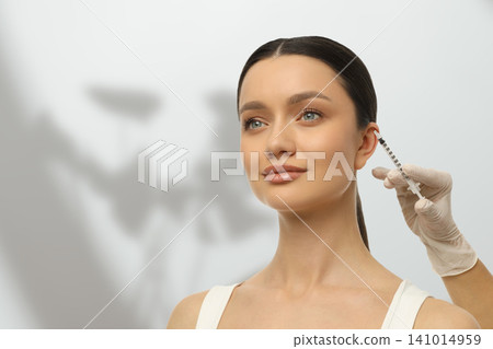 Woman gets injected with cosmetic solution in a skincare treatment Woman gets injected with cosmetic solution in a skincare treatment 141014959