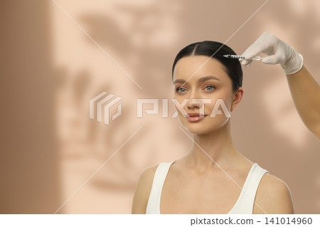 Woman with smooth skin receiving facial injection calmly Woman with smooth skin receiving facial injection calmly 141014960