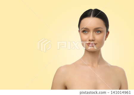 Woman poses gracefully with natural beauty against a soft background Woman poses gracefully with natural beauty against a soft background 141014961