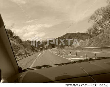 Driving on the highway while wearing sunglasses 141015442