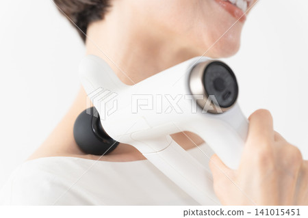 Woman using a massage machine Lifestyle image Woman using a massage machine Lifestyle image 141015451