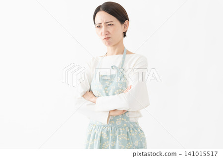 Woman wearing an apron Lifestyle image Woman wearing an apron Lifestyle image 141015517