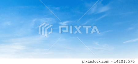 Clear blue sky with wispy, soft clouds drifting gently Clear blue sky with wispy, soft clouds drifting gently 141015576