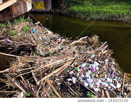 Garbage piled up under the river bridge Garbage piled up under the river bridge 141015720