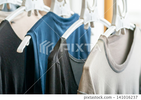 A close-up shot of underwear and T-shirts drying on hangers indoors. A close-up shot of underwear and T-shirts drying on hangers indoors. 141016237