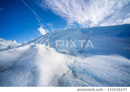 Glacier ice perito moreno glaciers blue sky landscape with snowy ridge and cloud over frozen Patagonia terrain Glacier ice perito moreno glaciers blue sky landscape with snowy ridge and cloud over frozen Patagonia terrain 141016247