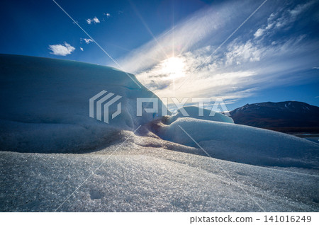 Perito moreno glaciers ice landscape sun sky mountain blue frozen scenic view with sparkling snow under bright light 141016249
