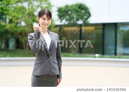 Asian business woman doing guts pose Asian business woman doing guts pose 141016308