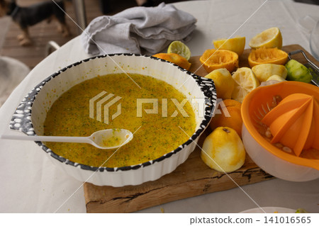 citrus juice preparation on a kitchen counter with vibrant colors and fresh ingredients, close-up view of juicer and squeezed peels, healthy lifestyle and food preparation context. citrus juice preparation on a kitchen counter with vibrant colors and fresh ingredients, close-up view of juicer and squeezed peels, healthy lifestyle and food preparation context. 141016565