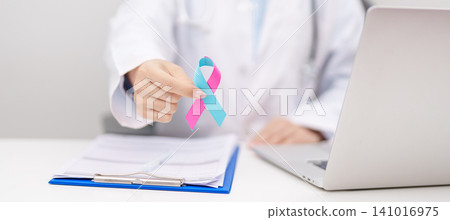 Doctor giving blue and pink ribbon to patient for concept of October male Breast Cancer Awareness month, National Cancer Survivors Month and Pink October Healthcare and February world cancer Doctor giving blue and pink ribbon to patient for concept of October male Breast Cancer Awareness month, National Cancer Survivors Month and Pink October Healthcare and February world cancer 141016975