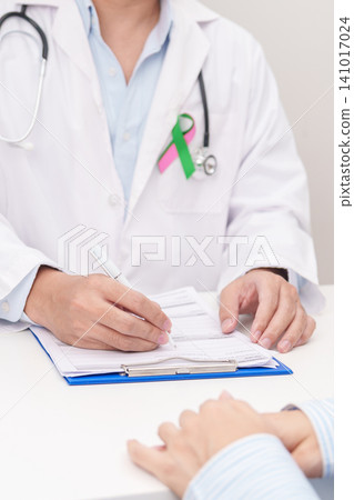 Doctor and patient having a medical consultation for green and pink ribbon to patient for concept of October Metastatic Breast Cancer Awareness month, National Cancer Survivors Month and Pink October Doctor and patient having a medical consultation for green and pink ribbon to patient for concept of October Metastatic Breast Cancer Awareness month, National Cancer Survivors Month and Pink October 141017024