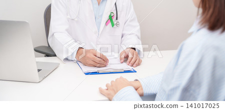 Doctor and patient having a medical consultation for green and pink ribbon to patient for concept of October Metastatic Breast Cancer Awareness month, National Cancer Survivors Month and Pink October Doctor and patient having a medical consultation for green and pink ribbon to patient for concept of October Metastatic Breast Cancer Awareness month, National Cancer Survivors Month and Pink October 141017025