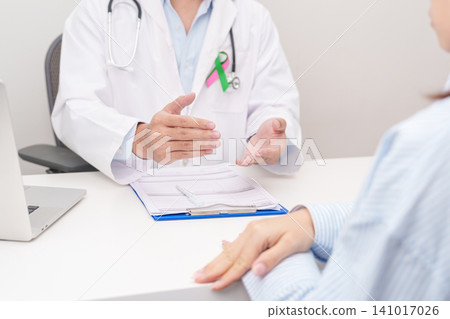 Doctor and patient having a medical consultation for green and pink ribbon to patient for concept of October Metastatic Breast Cancer Awareness month, National Cancer Survivors Month and Pink October Doctor and patient having a medical consultation for green and pink ribbon to patient for concept of October Metastatic Breast Cancer Awareness month, National Cancer Survivors Month and Pink October 141017026