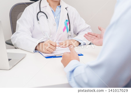 Doctor and patient having a medical consultation for blue and pink ribbon concept of October male Breast Cancer Awareness month, National Cancer Survivors Month and Pink October Healthcare Doctor and patient having a medical consultation for blue and pink ribbon concept of October male Breast Cancer Awareness month, National Cancer Survivors Month and Pink October Healthcare 141017029