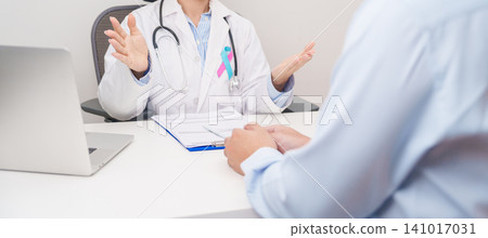 Doctor and patient having a medical consultation for blue and pink ribbon concept of October male Breast Cancer Awareness month, National Cancer Survivors Month and Pink October Healthcare Doctor and patient having a medical consultation for blue and pink ribbon concept of October male Breast Cancer Awareness month, National Cancer Survivors Month and Pink October Healthcare 141017031