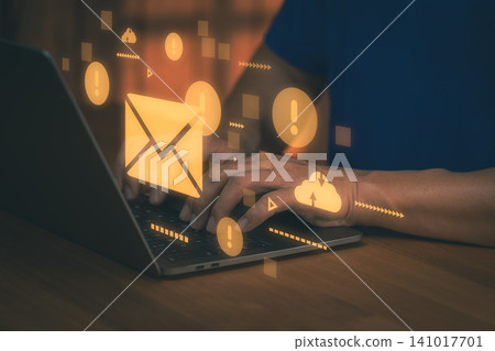 Man typing on laptop with email alert hologram. Cloud technology, digital business communication, spam warning and internet message concept. Man typing on laptop with email alert hologram. Cloud technology, digital business communication, spam warning and internet message concept. 141017701