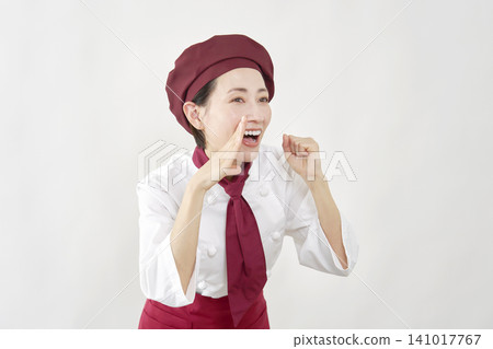 Female pastry chef calling out to the public, against a white background. 141017767