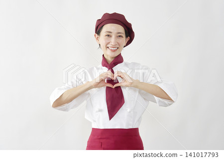 A female pastry chef making a heart shape A female pastry chef making a heart shape 141017793