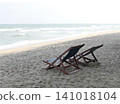 Beach chairs are placed on the sand by the sea. 141018104