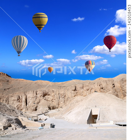 Famous tourist attraction balloon flight in Valley of Kings, Luxor, Egypt. Air balloons over the Theban Necropolis, Luxor, Egypt. Topic of vacation, travel, trip abroad on vacation, cruises and tours Famous tourist attraction balloon flight in Valley of Kings, Luxor, Egypt. Air balloons over the Theban Necropolis, Luxor, Egypt. Topic of vacation, travel, trip abroad on vacation, cruises and tours 141018453